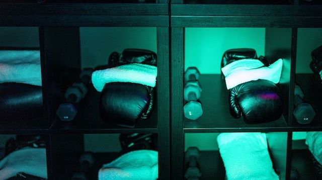 Gym shelves with boxing gloves and weights