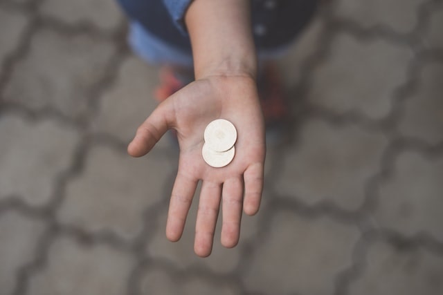 Hand holding coins