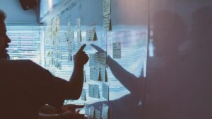 Man Pointing To Sticky Notes On A Whiteboard