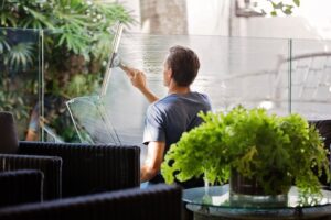 Man washing windows in a public building