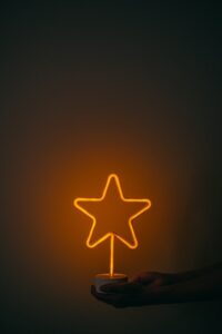 Person holding a neon star light