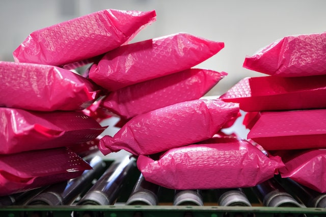 Pink shipping packages on a conveyor belt