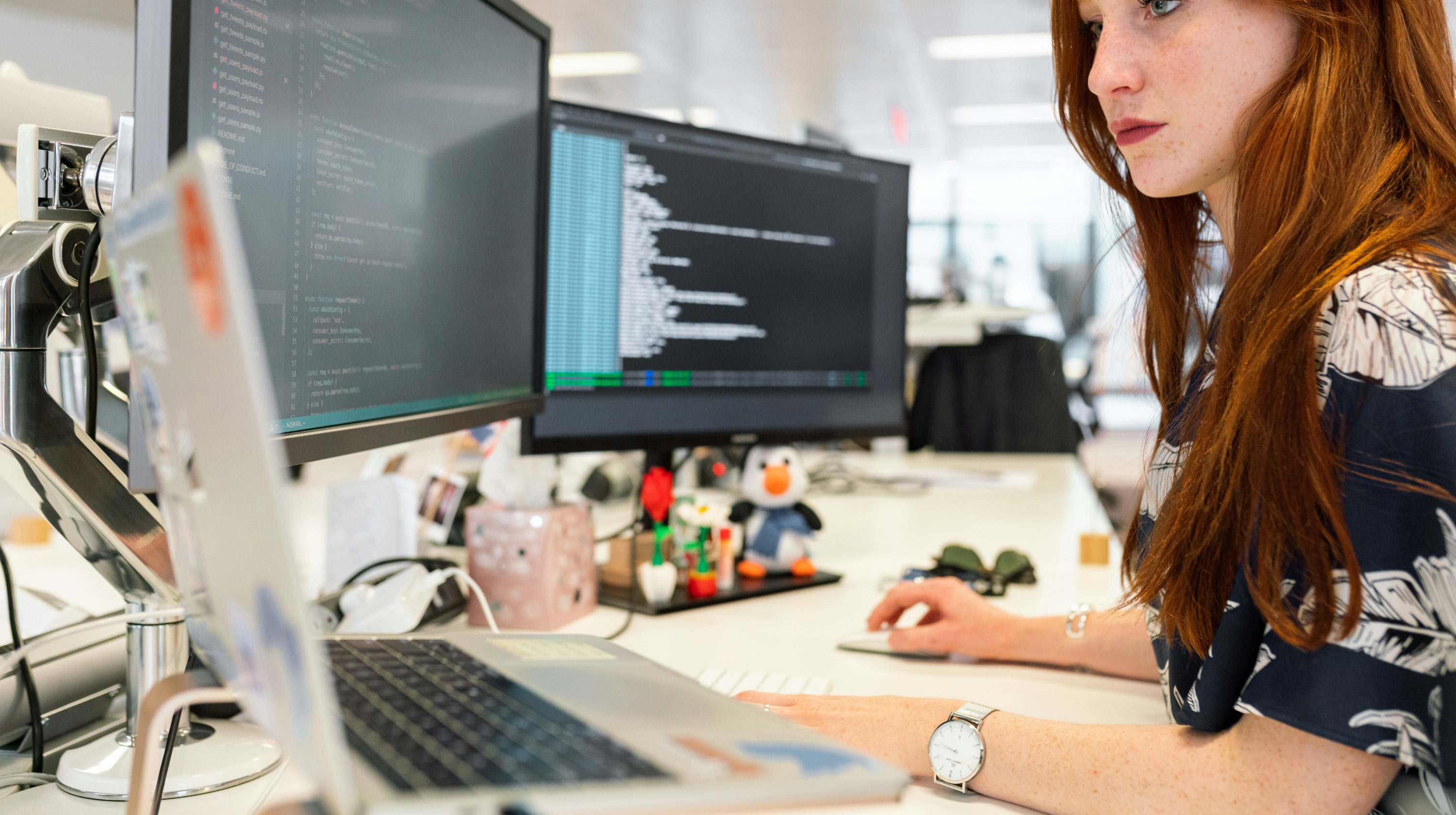 Female web developer at work at her desk