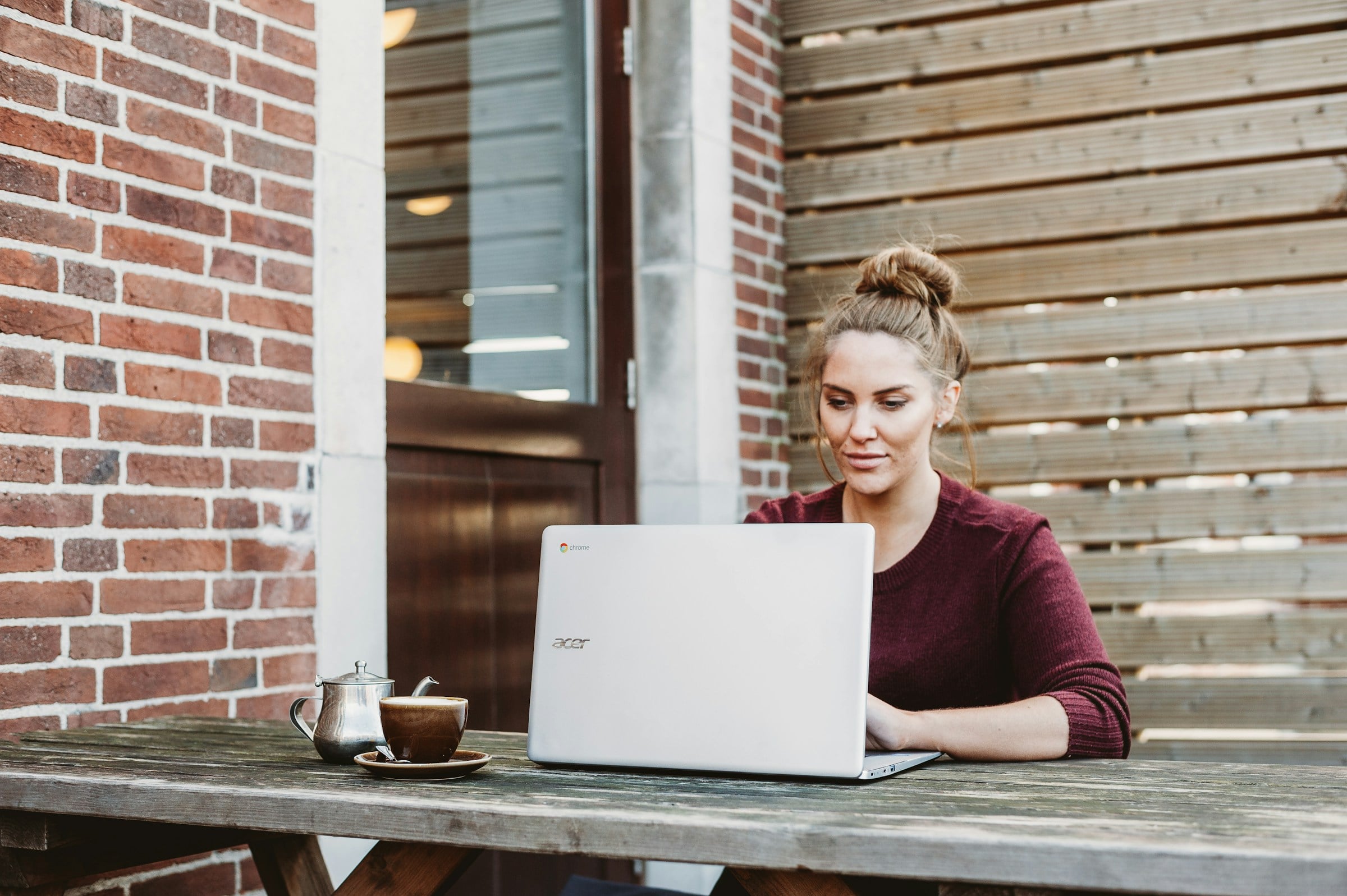 Woman working at a laptop outside