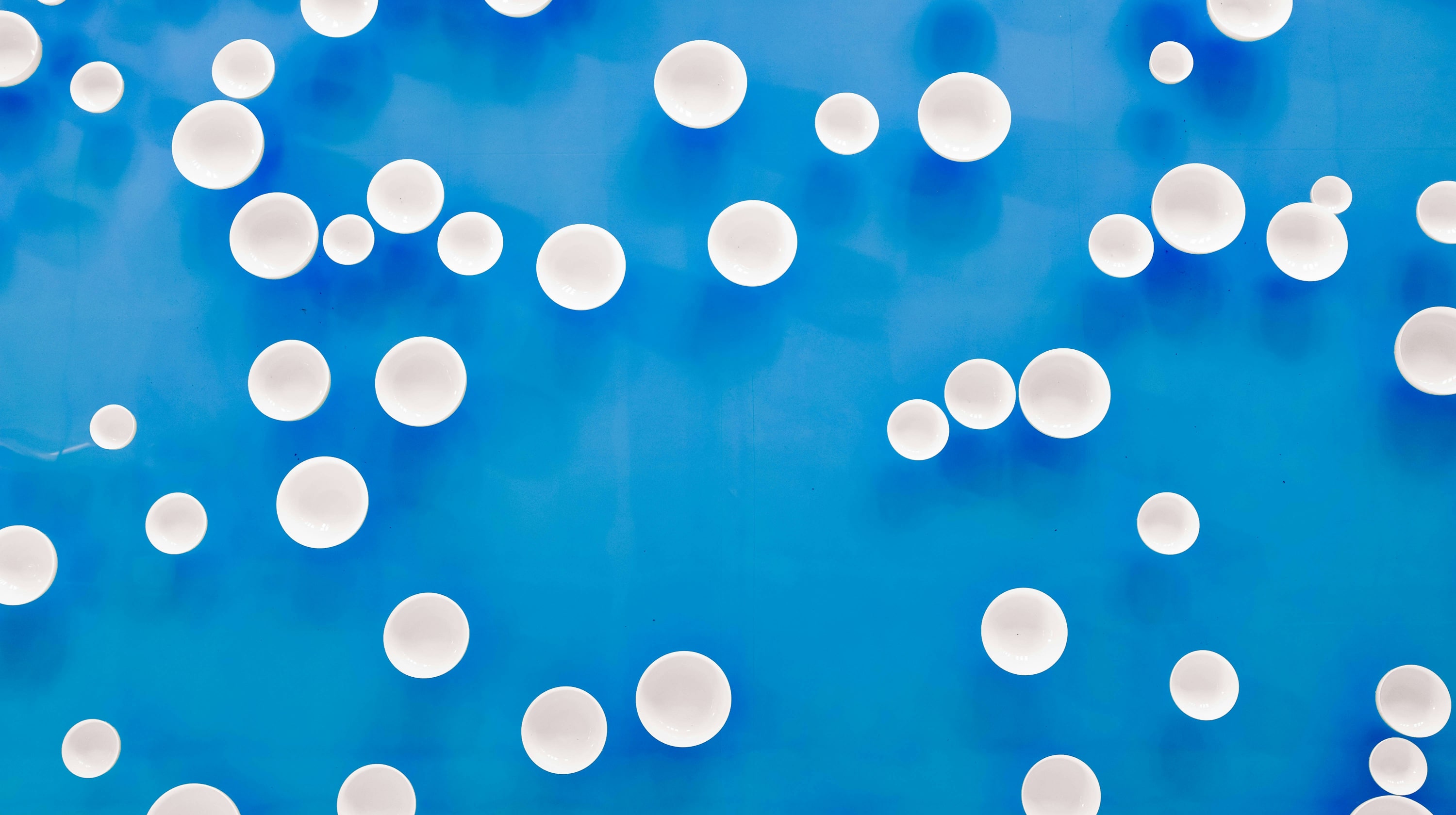 White dots against a bright blue background