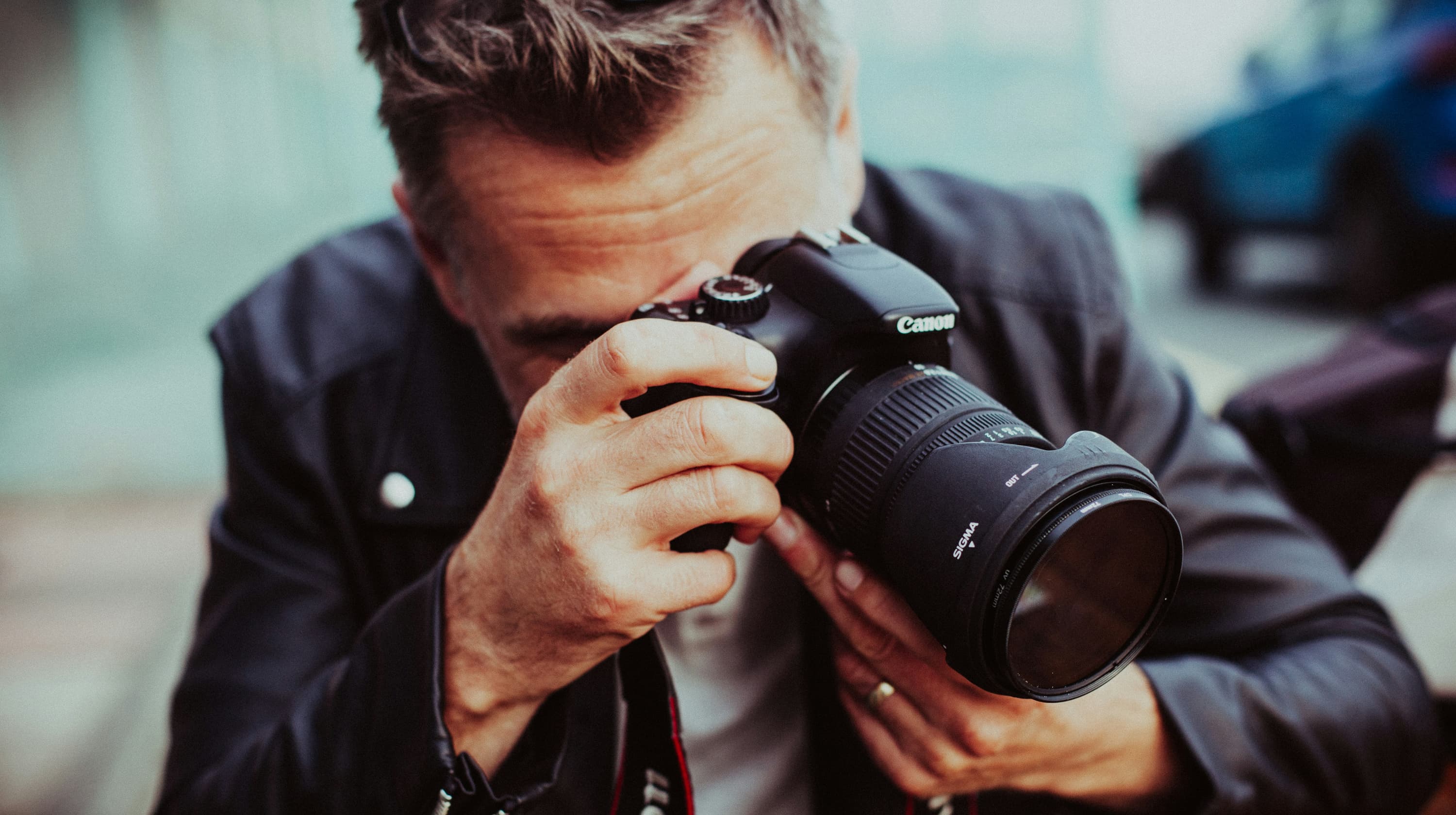 Man with a Canon camera taking a photo