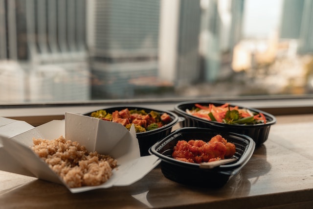 Takeout food sitting on a table overlooking a cityscape