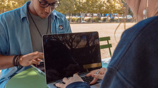 Two Gen z workers on laptops