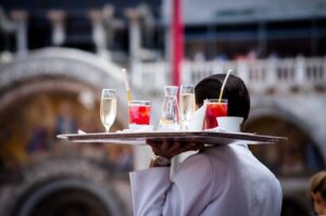 waiter carrying a tray of drinks