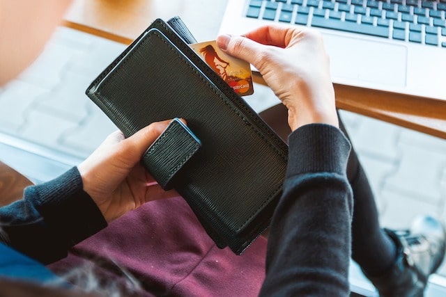 Woman pulling bank card out of wallet