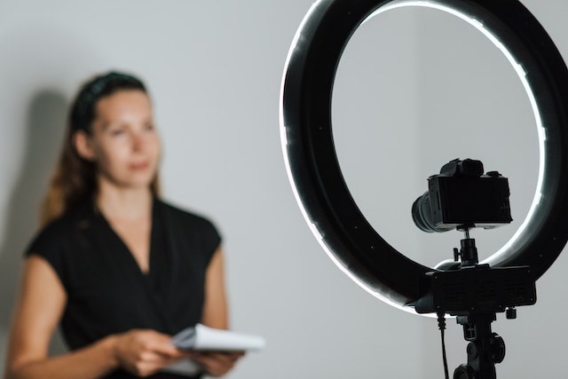 Woman standing in front of camera equipment