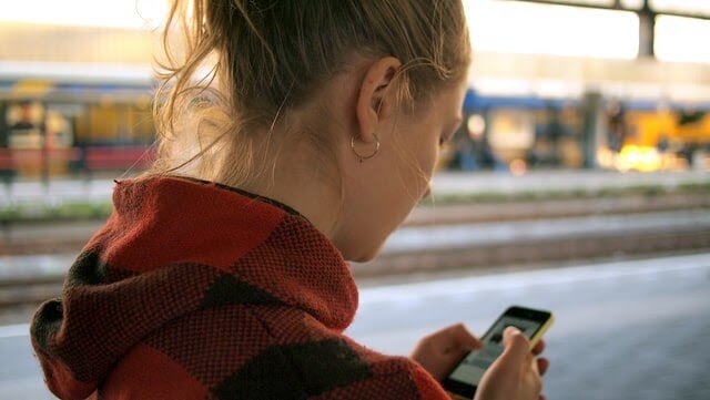 Woman standing outside looking at her smartphone