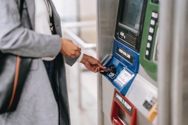 Woman using walk-up atm machine