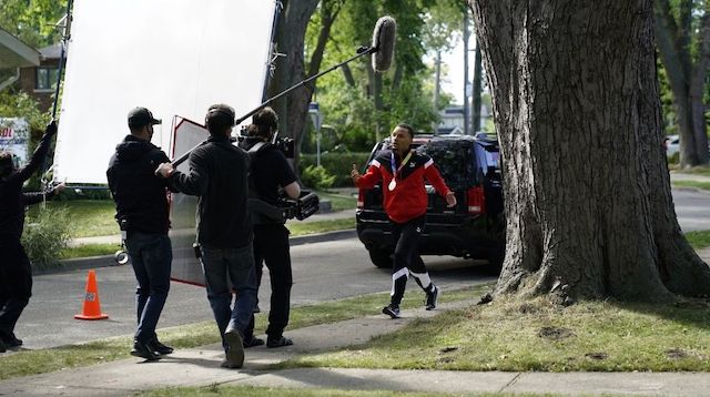 Andre De Grasse walking on the street while being filmed