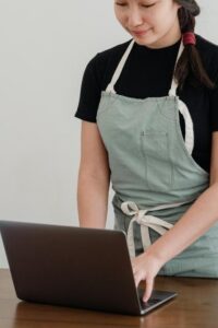 Barista Working on Laptop to Set Discount Code