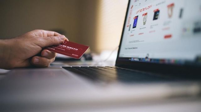 Man Holding Card Ordering from Website