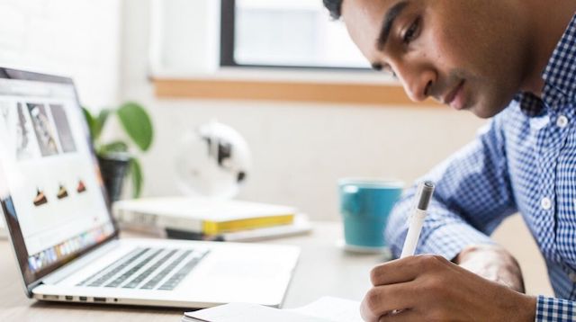 Business Intelligence Man Writing with Pen