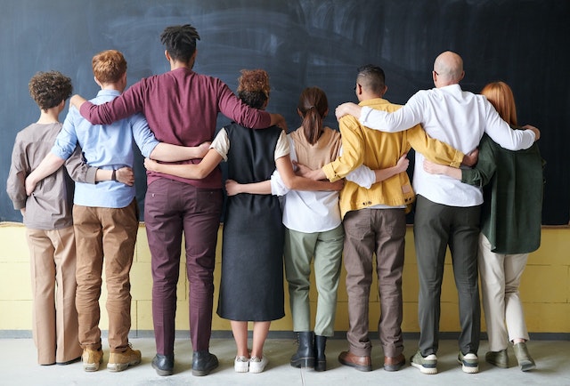 Diverse Group of People Lined Up Arm in Arm