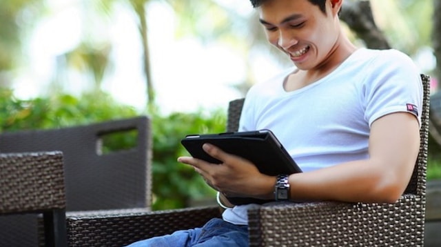 Online Advertising Man Reading Tablet Outside