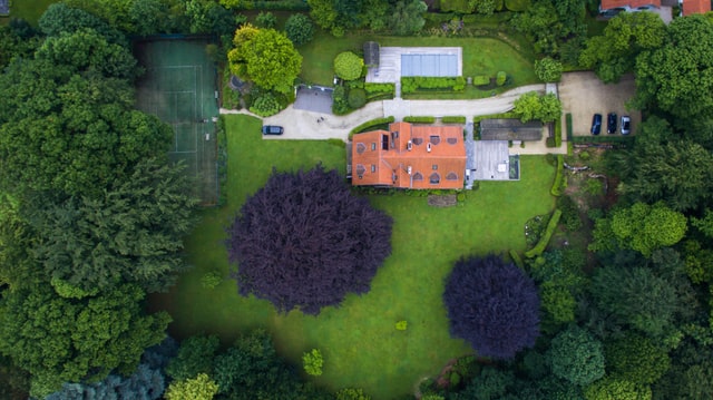 Overhead View of Large House in Wooded Setting