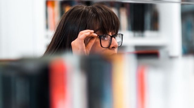 Real Estate Courses Woman Adjusting Glasses