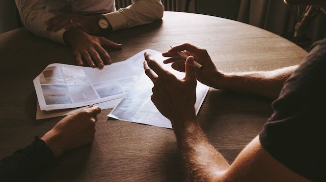 Real Estate License People Sitting at Table