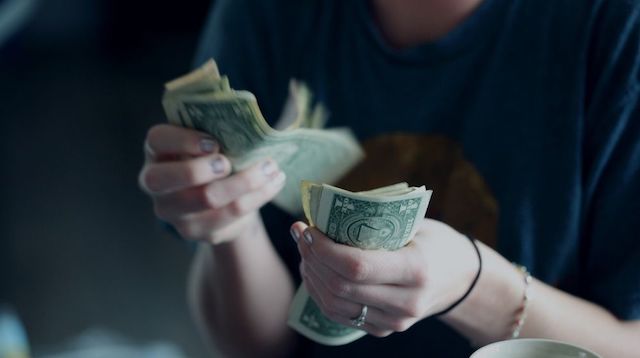 Trial Balance Woman Counting Dollar Bills