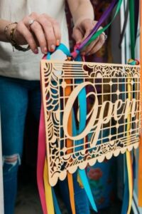 Woman Hanging Open Sign in Business Window