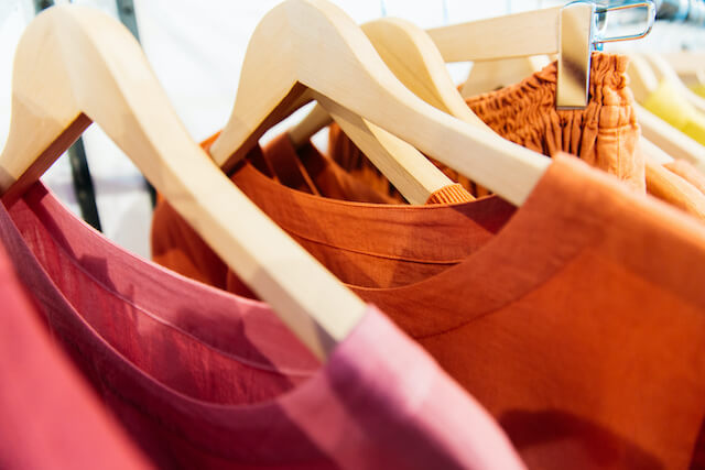 Close-up of brightly colored clothes on a store rack