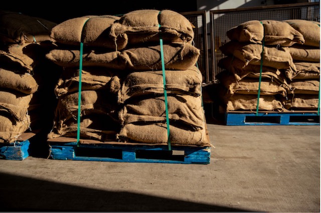 Large sacks of product sitting on pallets in warehouse