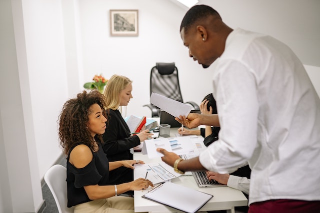 Man scolding woman in workplace environment