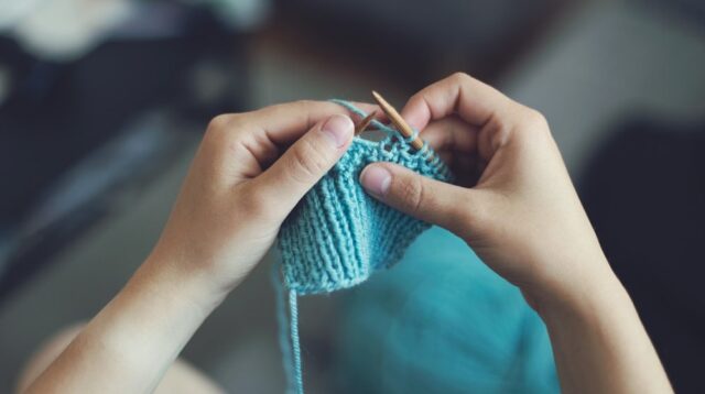 Person Knitting with blue yarn