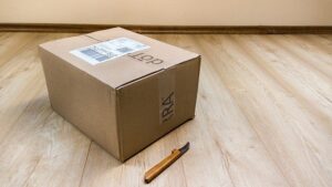 Cardboard shipping box sitting on wood floor