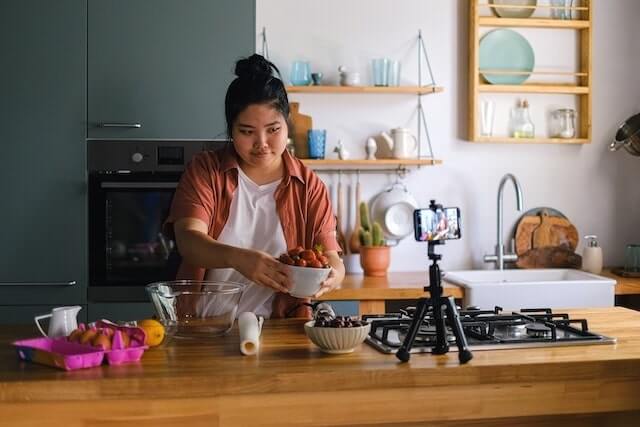 Cook shooting a video in a kitchen