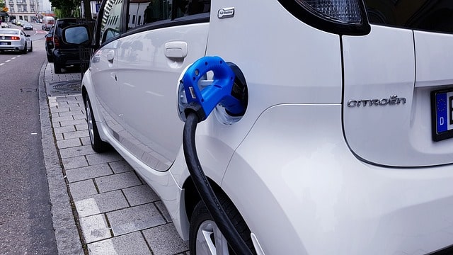 Electric car plugged in to charging station