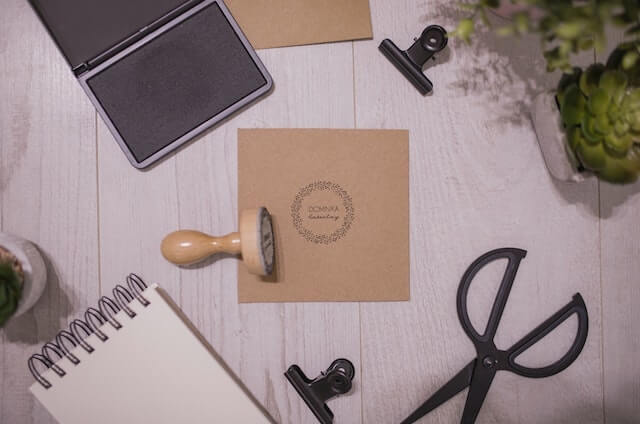 Handmade business card with rubber stamp on table