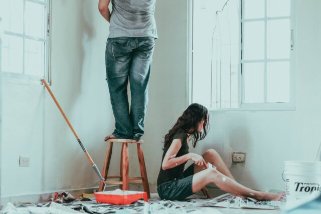 Two people painting a room