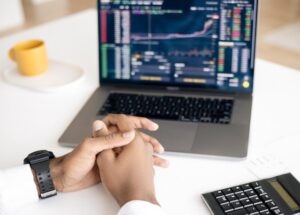 Man looking at stock returns on a laptop