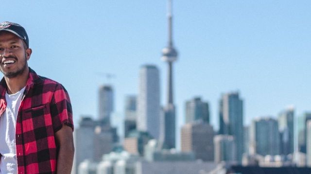 Man posing against a Toronto skyline