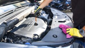 Mechanic checking the oil in a car