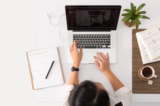 Overhead view of the woman working on a laptop