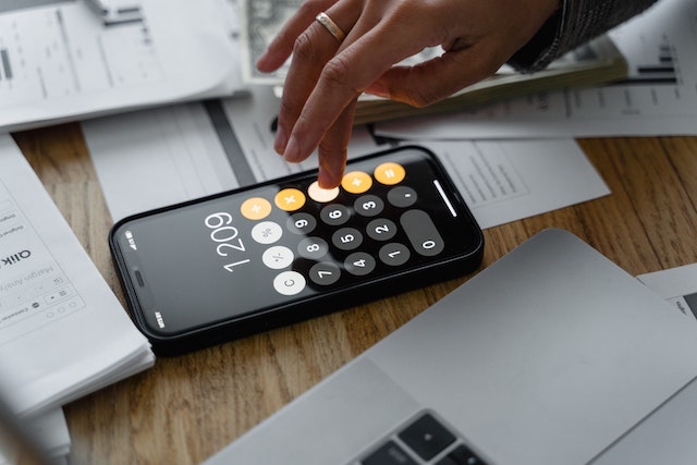 Person calculating numbers on a mobile phone