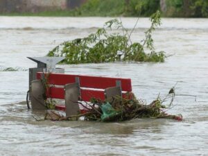 Red park bench engulfed in flood