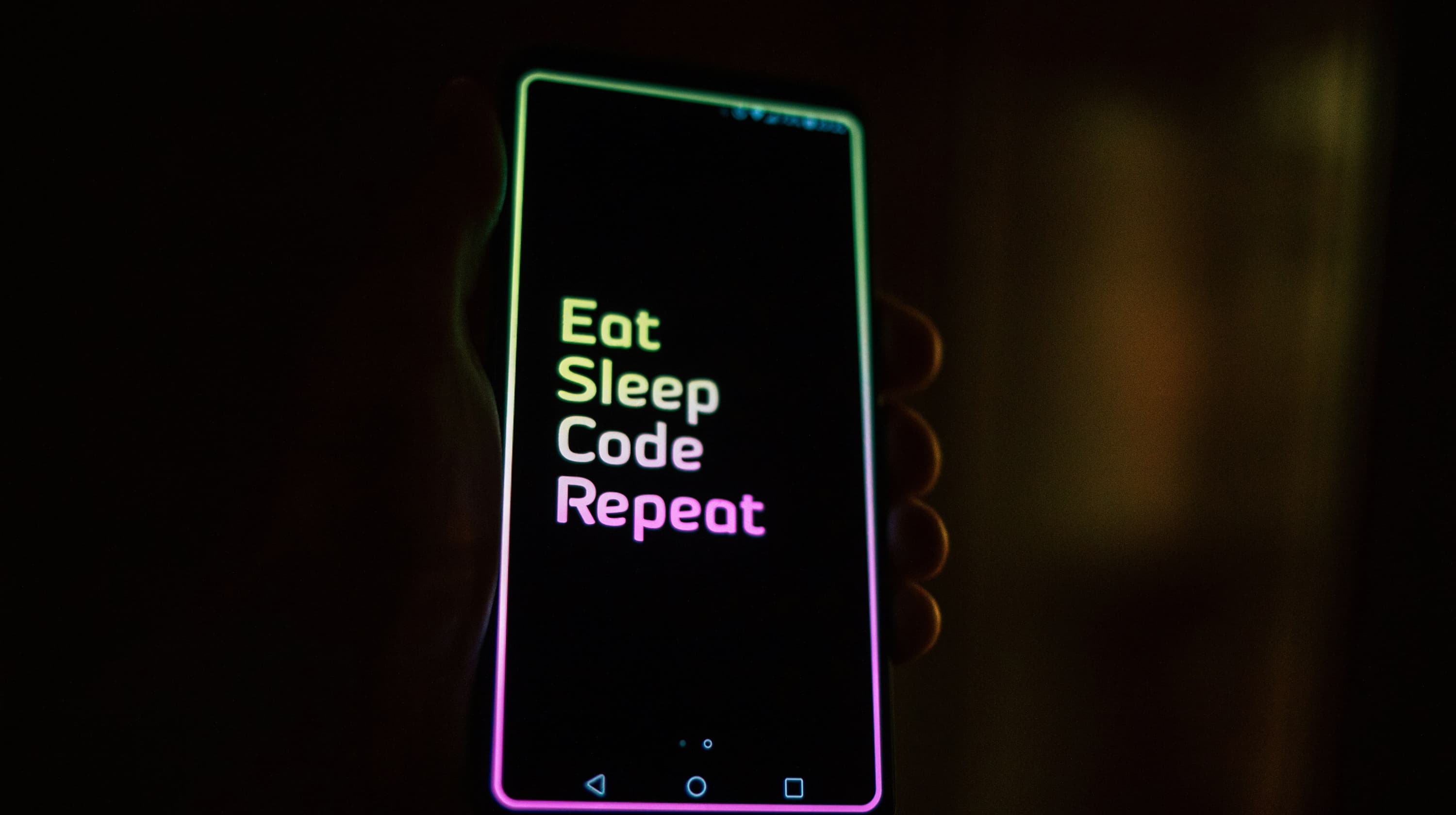 Phone screen with the words "eat, sleep, code, repeat"