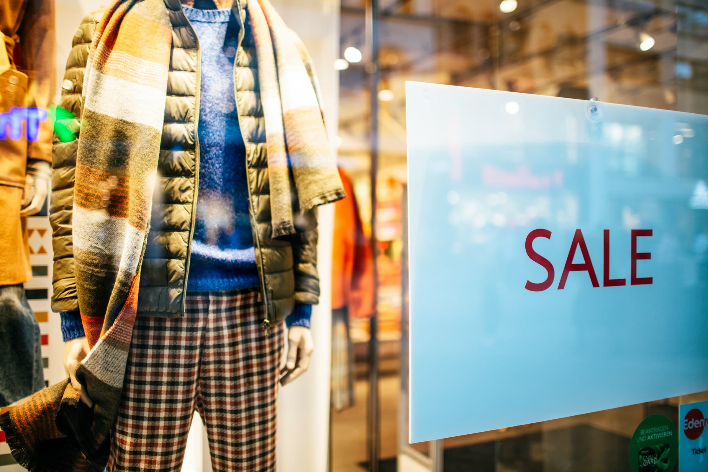 Clothing store window with a SALE sign