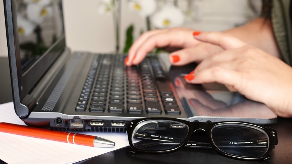 Woman typing on a laptop