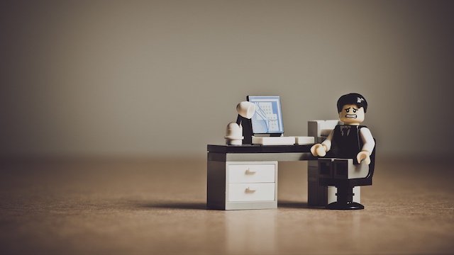 Stressed out Lego man sitting at a desk