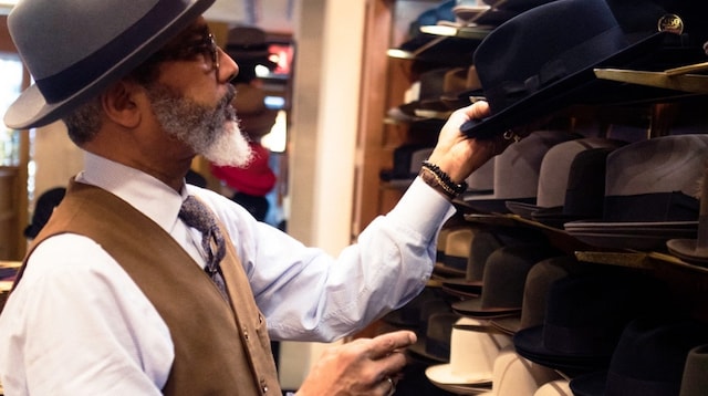 Business Succession Plan Man Examining Hats