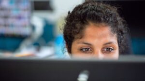 Woman seen from behind her desk