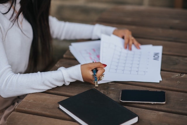 Woman jotting notes on calendar